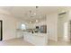 Modern kitchen boasts white cabinetry, stainless steel appliances, and a spacious island for meal preparation at 15154 Appleton Blvd, Port Charlotte, FL 33981