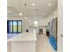 Contemporary kitchen with a large island, stainless steel appliances, and scenic views from the sliding glass doors at 15154 Appleton Blvd, Port Charlotte, FL 33981