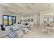 Bright living room with coffered ceilings, seamlessly connecting to a modern kitchen with stainless steel appliances at 15154 Appleton Blvd, Port Charlotte, FL 33981