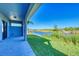 Covered patio overlooking a lush backyard and a peaceful canal view at 15154 Appleton Blvd, Port Charlotte, FL 33981