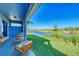 Relaxing covered patio overlooking a serene canal, featuring comfortable seating and lush greenery at 15154 Appleton Blvd, Port Charlotte, FL 33981