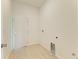A utility room with a white door and electrical and water hookups for appliances at 15154 Appleton Blvd, Port Charlotte, FL 33981
