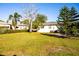 Spacious backyard with grassy lawn, hammock, and mature trees at 2109 58Th S St, Gulfport, FL 33707