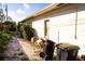 Backyard with gravel path, landscaping, and trash cans at 2109 58Th S St, Gulfport, FL 33707