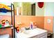 Bathroom with pink tile, a vanity with a sink, and a shower/tub combo at 2109 58Th S St, Gulfport, FL 33707