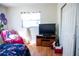 Bedroom with wood floors, a TV stand, and double doors to closet at 2109 58Th S St, Gulfport, FL 33707