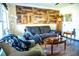 Living area with wood-look floors, comfy seating, and a rustic wall at 2109 58Th S St, Gulfport, FL 33707