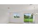 Bright and airy living room with large windows and sliding glass doors to the backyard at 31907 Anchor Point Dr, Wesley Chapel, FL 33545