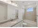Bathroom with a white vanity, granite countertop, bathtub and tiled shower at 31907 Anchor Point Dr, Wesley Chapel, FL 33545