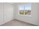 Bedroom with a window and a double door closet at 31907 Anchor Point Dr, Wesley Chapel, FL 33545