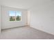 Bright bedroom featuring a large window with a view of the neighborhood at 31907 Anchor Point Dr, Wesley Chapel, FL 33545