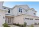 Charming two-story townhouse with a two-car garage, landscaped yard, and covered entryway at 31907 Anchor Point Dr, Wesley Chapel, FL 33545