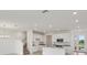 Open concept kitchen with an island, stainless appliances, and a view of the stairs at 31907 Anchor Point Dr, Wesley Chapel, FL 33545