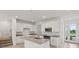 Bright, open kitchen with white cabinets, granite countertops, and stainless steel appliances at 31907 Anchor Point Dr, Wesley Chapel, FL 33545