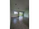 Bright and airy living room with large windows and sliding glass doors to the backyard at 31907 Anchor Point Dr, Wesley Chapel, FL 33545