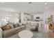 Spacious living room featuring tile flooring, a modern kitchen and an elegant dining area at 31907 Anchor Point Dr, Wesley Chapel, FL 33545