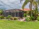 Home with a screened patio and landscaped backyard at 4943 Sandy Brook Cir, Wimauma, FL 33598
