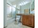 Updated bathroom with a tub shower combo, toilet, and vanity with wood cabinets at 4943 Sandy Brook Cir, Wimauma, FL 33598