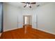 An empty bedroom with wood flooring, white trim, and a ceiling fan at 4943 Sandy Brook Cir, Wimauma, FL 33598