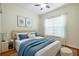 Bright bedroom with a queen-size bed, wood floors, and neutral decor at 4943 Sandy Brook Cir, Wimauma, FL 33598