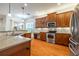 Spacious kitchen with stainless steel appliances and wood cabinets at 4943 Sandy Brook Cir, Wimauma, FL 33598