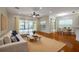 Bright living room with hardwood floors, sliding glass doors, and comfortable seating at 4943 Sandy Brook Cir, Wimauma, FL 33598