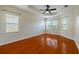Spacious main bedroom with hardwood floors and a ceiling fan at 4943 Sandy Brook Cir, Wimauma, FL 33598