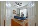 Bright office space with a ceiling fan, wooden floors, a blue desk, and natural light at 4943 Sandy Brook Cir, Wimauma, FL 33598