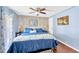 Bedroom with a king-sized bed, ceiling fan, and beautiful natural light at 7048 El Meyers St, Zephyrhills, FL 33541
