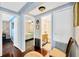 Hallway with wood floors leads to the bedrooms and bathroom at 7048 El Meyers St, Zephyrhills, FL 33541