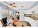 Kitchen has white appliances, granite countertops and a wooden table at 7048 El Meyers St, Zephyrhills, FL 33541