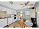 Well-lit kitchen with white appliances, wooden table and neutral color at 7048 El Meyers St, Zephyrhills, FL 33541