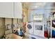 Laundry room featuring a washing machine, dryer, sink, and storage cabinets at 7048 El Meyers St, Zephyrhills, FL 33541