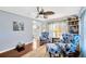 Bright living room features hardwood floors and two chairs with blue floral pattern at 7048 El Meyers St, Zephyrhills, FL 33541