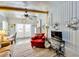 Cozy living room featuring a red arm chair and a mounted TV at 7048 El Meyers St, Zephyrhills, FL 33541
