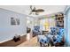 Bright living room features hardwood floors and two chairs with blue floral pattern at 7048 El Meyers St, Zephyrhills, FL 33541