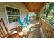 Covered porch with rocking chairs, overlooking the yard at 12106 Dagwood Way, Riverview, FL 33579