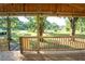 Wooden porch with a view of a backyard and trees at 12106 Dagwood Way, Riverview, FL 33579