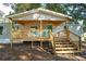 Inviting front porch with wooden deck, railings, and stairs leading to the entrance at 12106 Dagwood Way, Riverview, FL 33579