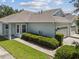 Gray house with two-car garage and neatly trimmed hedges at 6919 Surrey Hill Pl, Apollo Beach, FL 33572