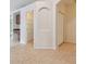 Tiled hallway with pantry and coat closet at 6919 Surrey Hill Pl, Apollo Beach, FL 33572