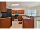 Kitchen with wood cabinets, stainless steel appliances and breakfast bar at 6919 Surrey Hill Pl, Apollo Beach, FL 33572