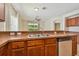 Kitchen with double sink and view into living area at 6919 Surrey Hill Pl, Apollo Beach, FL 33572