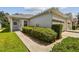 Single story home with two-car garage and manicured hedges at 6919 Surrey Hill Pl, Apollo Beach, FL 33572