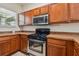 Gas range and built-in microwave in kitchen at 6919 Surrey Hill Pl, Apollo Beach, FL 33572