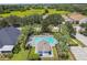 Community pool with surrounding lounge chairs and landscaping at 6919 Surrey Hill Pl, Apollo Beach, FL 33572