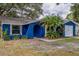 Bright blue house with a white garage door and landscaping at 3303 Russett Dr, Tampa, FL 33618