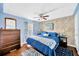 Primary bedroom featuring a king-size bed and wood flooring at 7048 El Meyers St, Zephyrhills, FL 33541