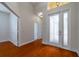 Bright and spacious entryway with hardwood floors and access to other rooms at 4943 Sandy Brook Cir, Wimauma, FL 33598