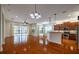 Open living room with hardwood floors, kitchen island and sliding glass doors leading to patio at 4943 Sandy Brook Cir, Wimauma, FL 33598